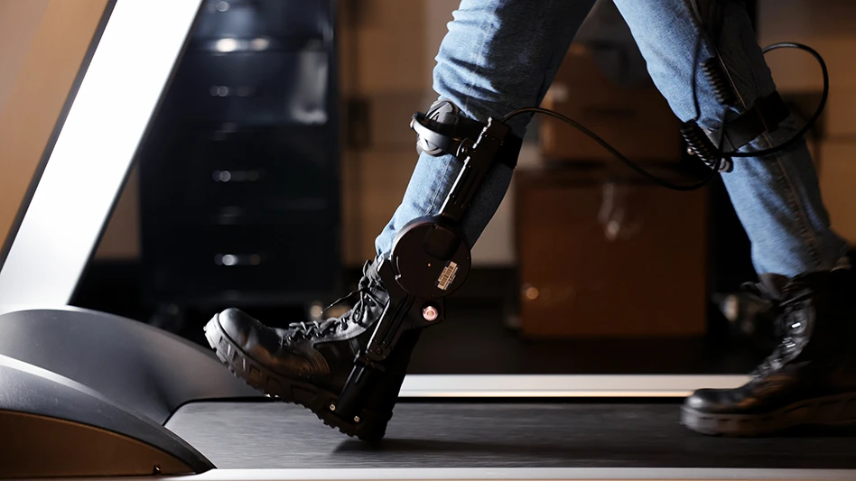 Jacqueline Hannan, a PhD student in industrial and operations engineering, demonstrates walking with an ankle exoskeleton in Stirling's lab.