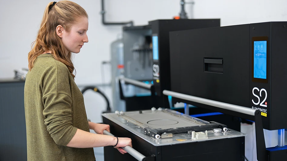 woman in front of sintratec s2 am machine